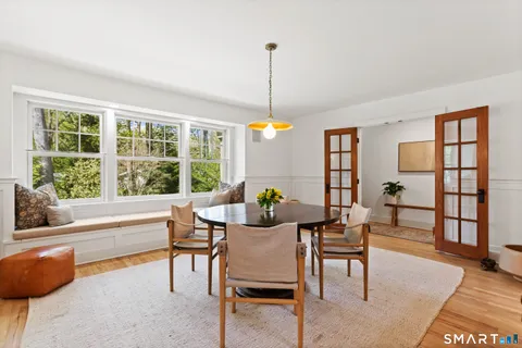 a dining room with a fireplace and a rug