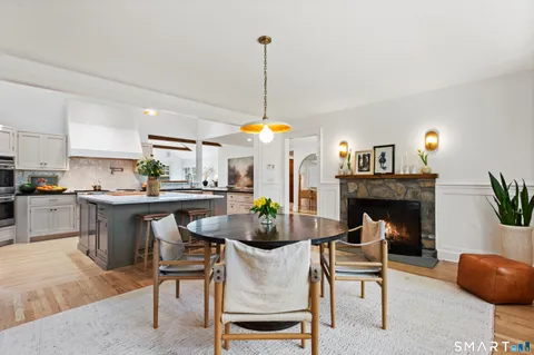a dining room with furniture a chandelier and window