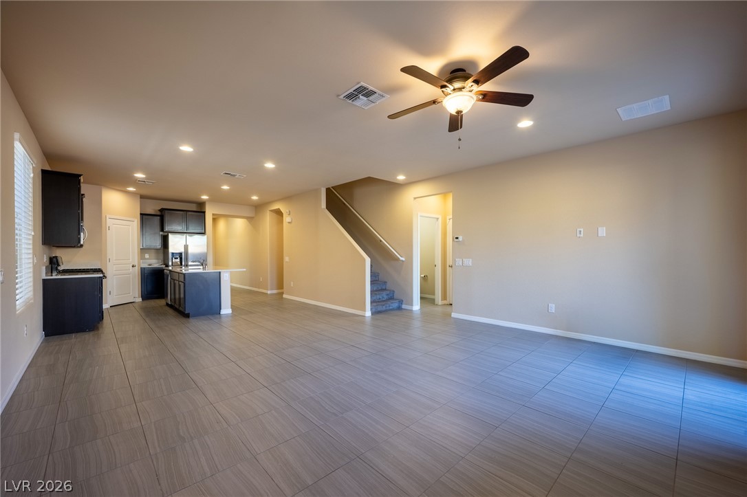 11016 Prairie Grove Road Las Vegas, NV 89179 - Photo 37 of 37 An open floorplan with tile flooring and a kitchen island creates a functional living space.