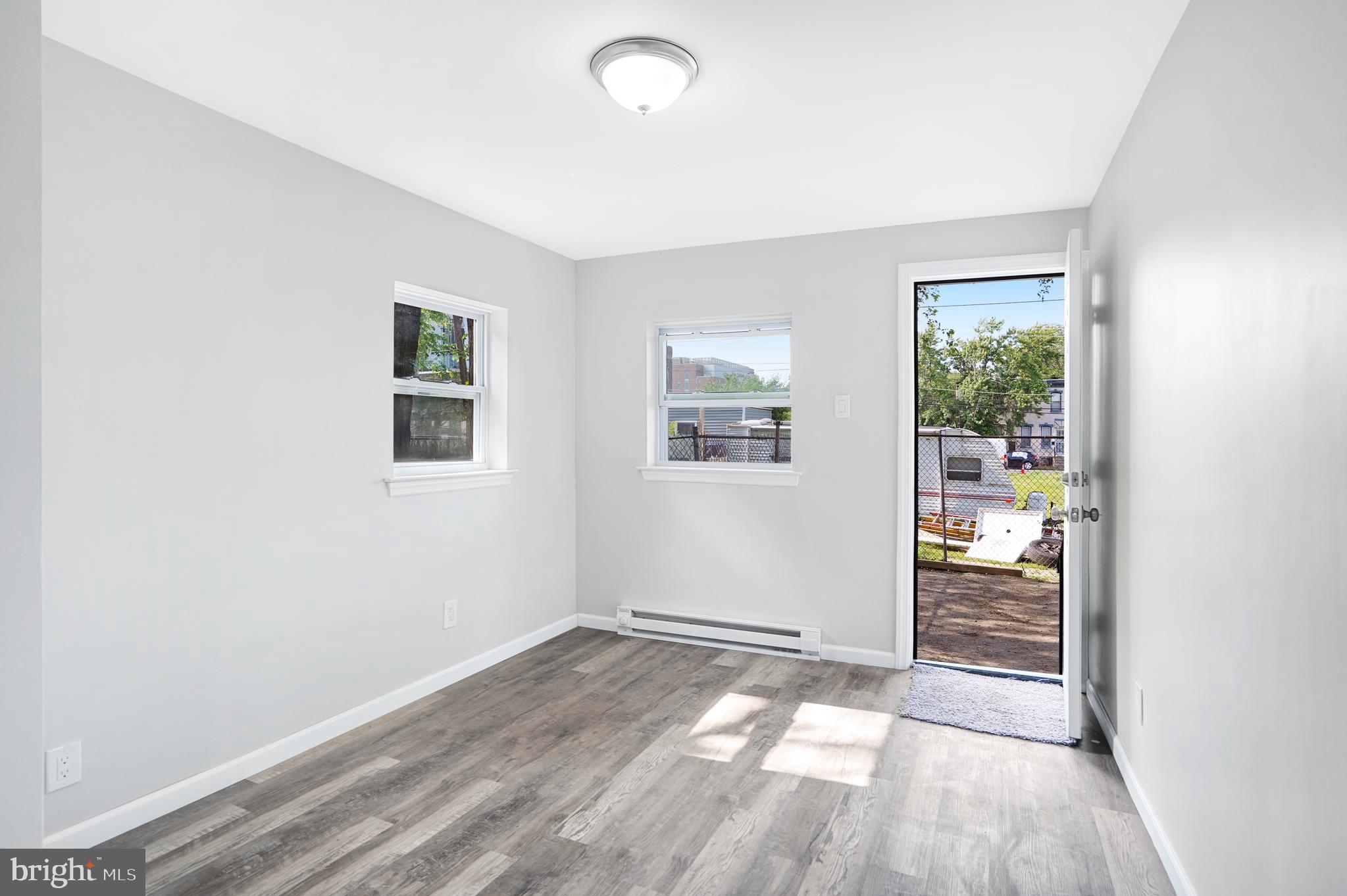 565 Line Street Camden, NJ 08103 - Photo 12 of 31 an empty room with wooden floor and windows