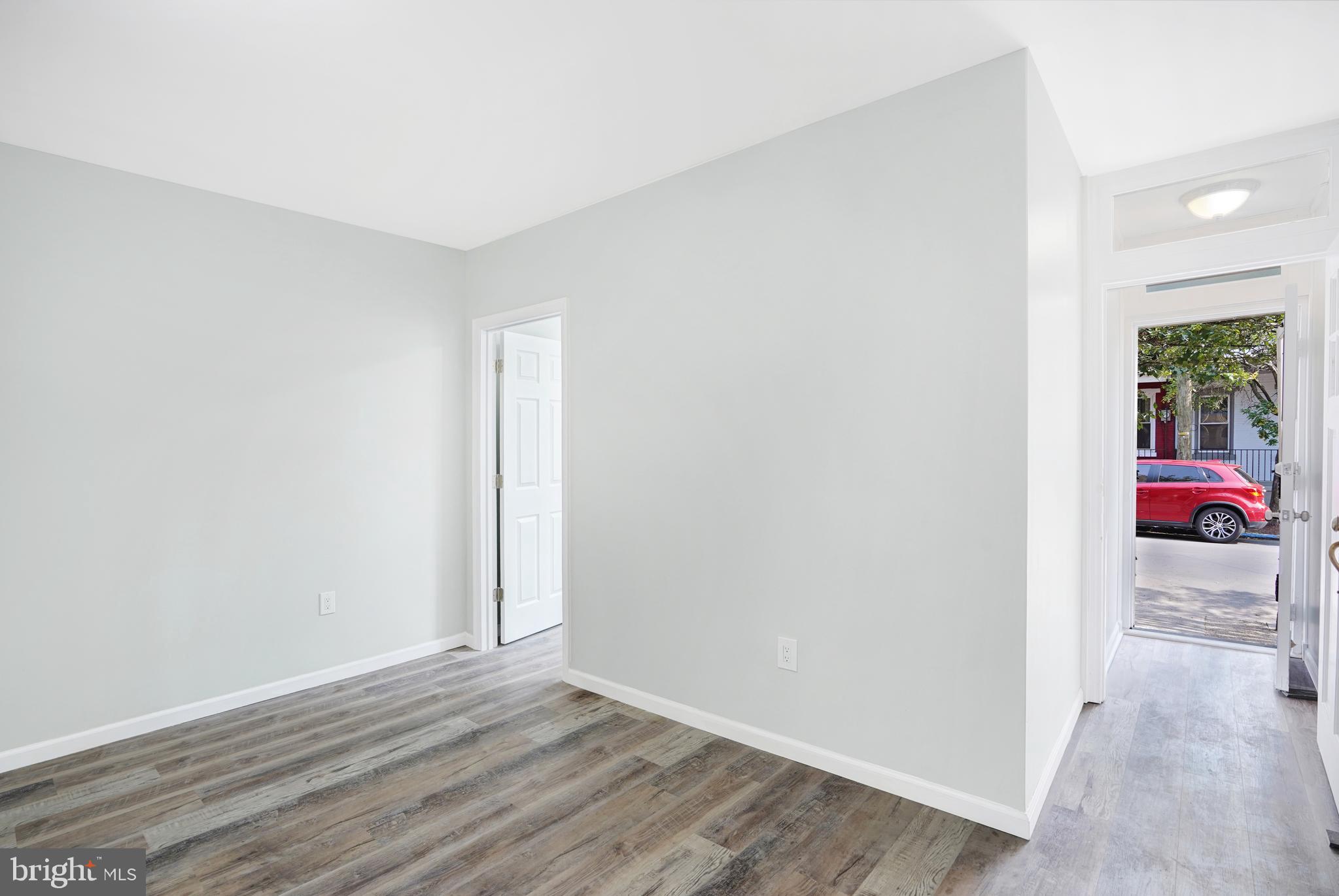 565 Line Street Camden, NJ 08103 - Photo 5 of 31 an empty room with wooden floor and windows