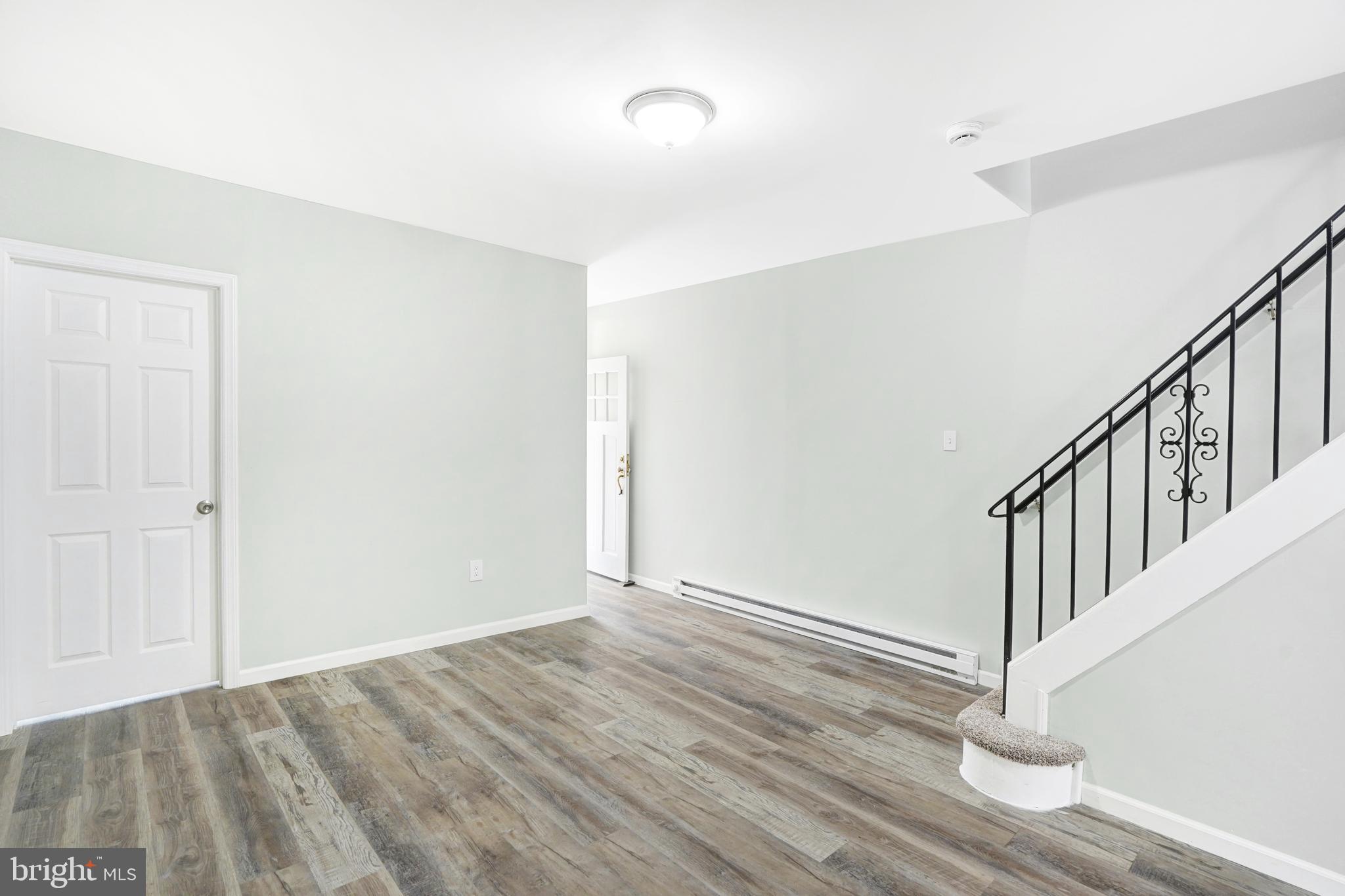 565 Line Street Camden, NJ 08103 - Photo 6 of 31 a view of a hallway with wooden floor and staircase