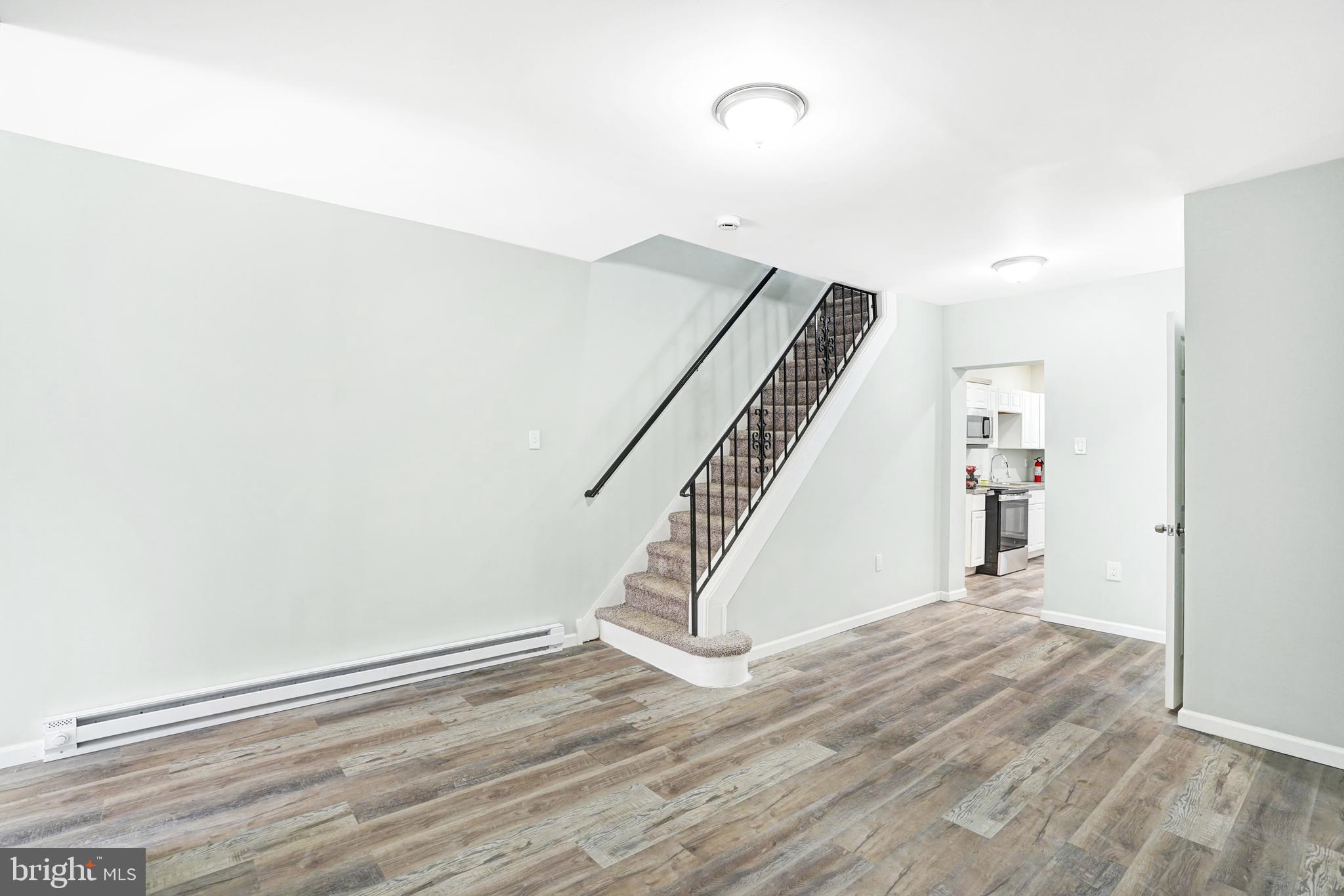 565 Line Street Camden, NJ 08103 - Photo 7 of 31 a view of an empty room with wooden floor and stairs