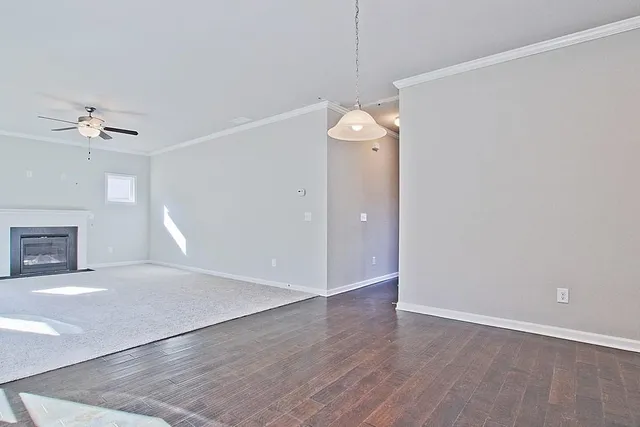 an empty room with a fireplace and fan
