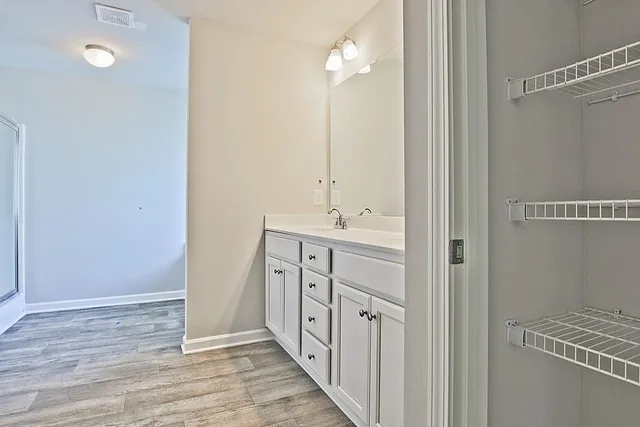 a bathroom with a double vanity sink a and mirror