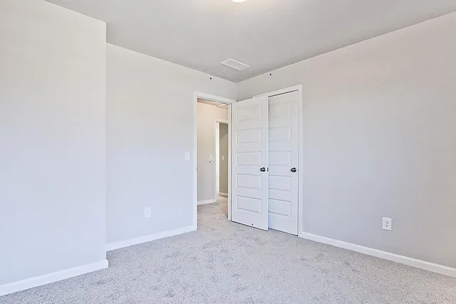an empty room with closet area