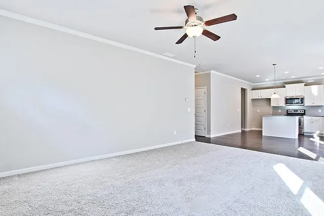 a view of a kitchen with a sink and a chandelier fan