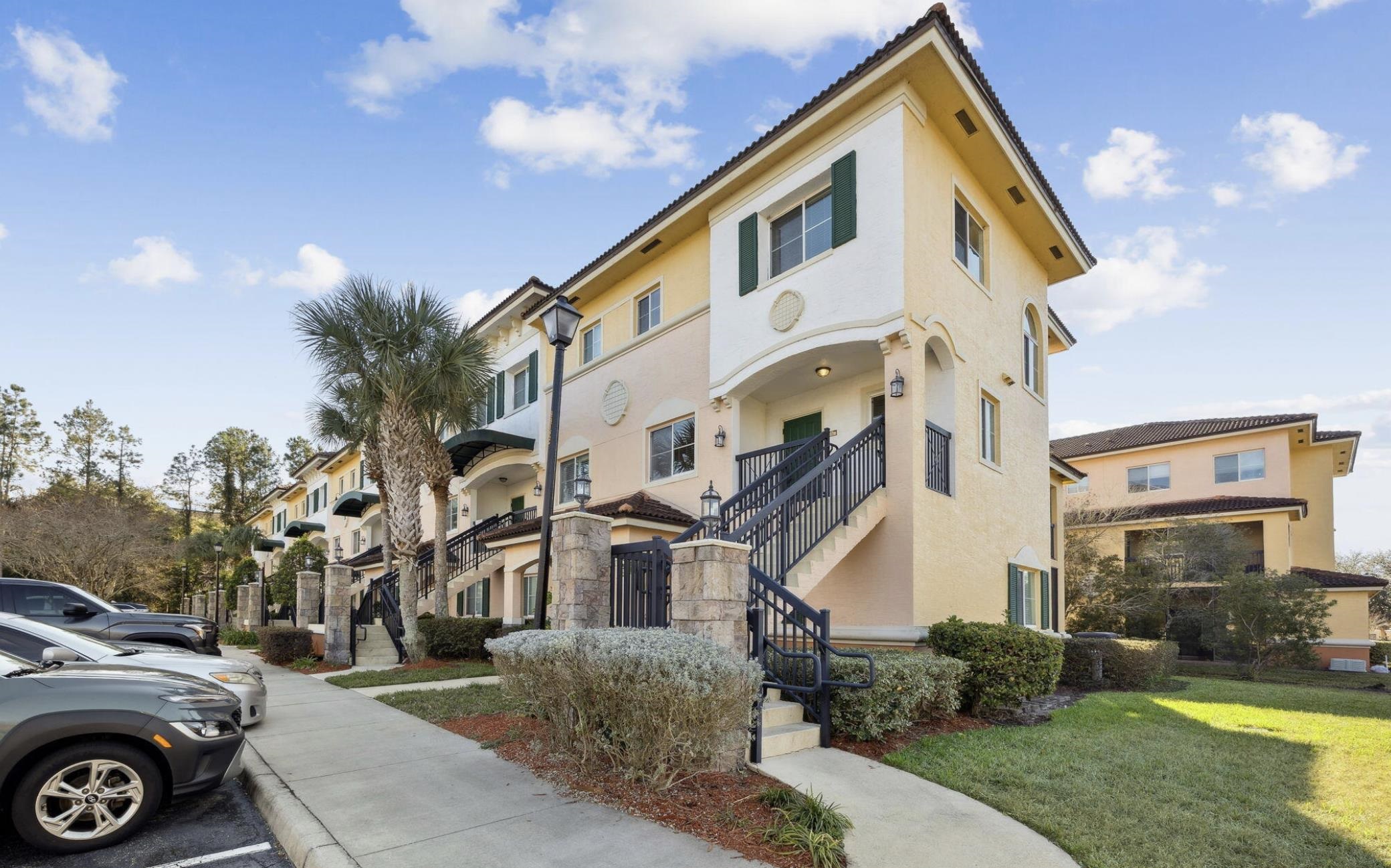 9745 Touchton Road, Unit 2125 Jacksonville, FL 32246 - Photo 1 of 1 a view of a white house next to a yard with big trees