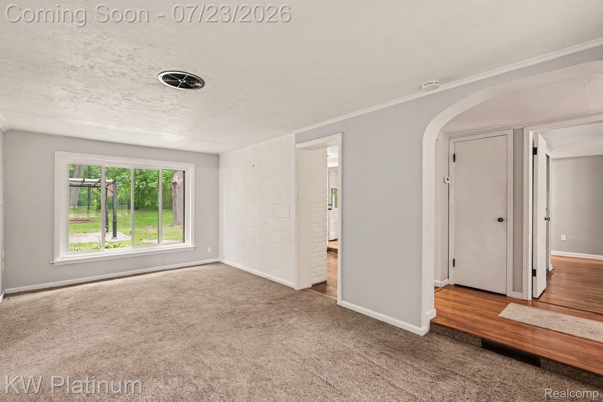 4885 Lakeshore Road Fort Gratiot, MI 48059 - Photo 10 of 26 Carpeted room with a large window, light gray wall paint, and white trim