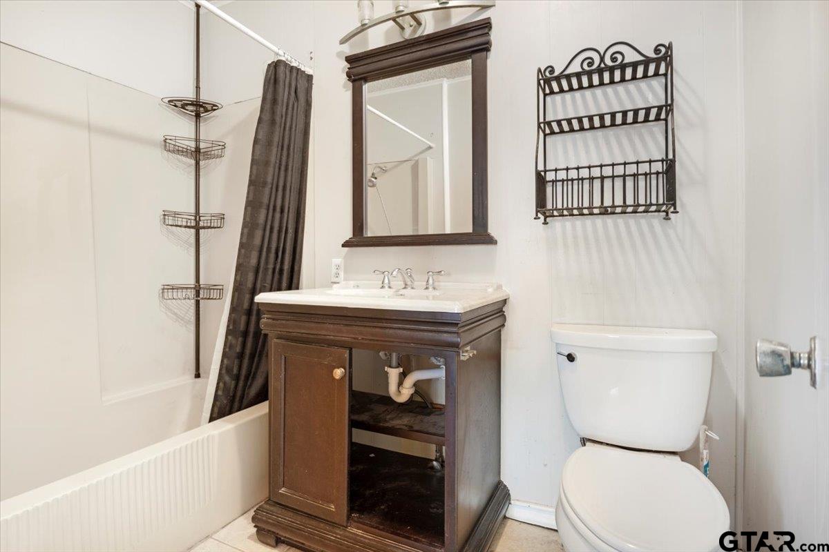 6521 Highway 271 Tyler, TX 75708 - Photo 26 of 35 a bathroom with a sink a toilet and shower