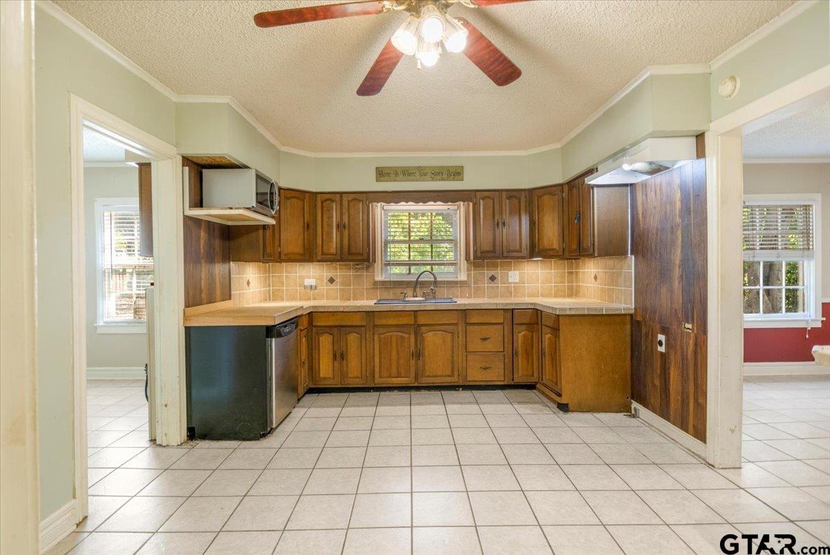 6521 Highway 271 Tyler, TX 75708 - Photo 6 of 35 a kitchen with stainless steel appliances granite countertop a sink counter space cabinets and a large window