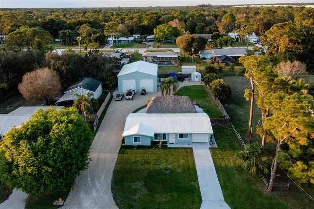 an aerial view of a house with yard swimming pool and outdoor seating