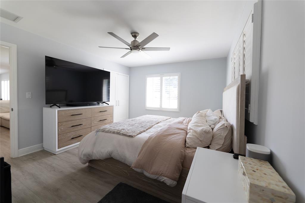 1497 Southwest Buckskin Trail Stuart, FL 34997 - Photo 13 of 48 a bedroom with a bed and a flat screen tv