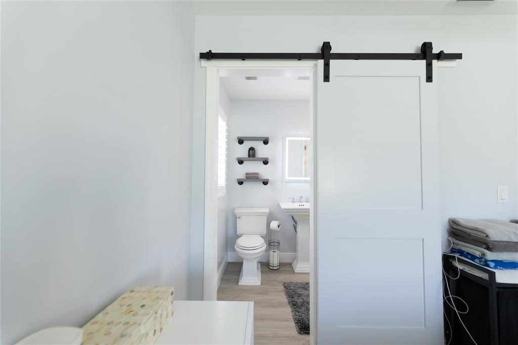 1497 Southwest Buckskin Trail Stuart, FL 34997 - Photo 15 of 48 a bathroom with a toilet a sink and shower