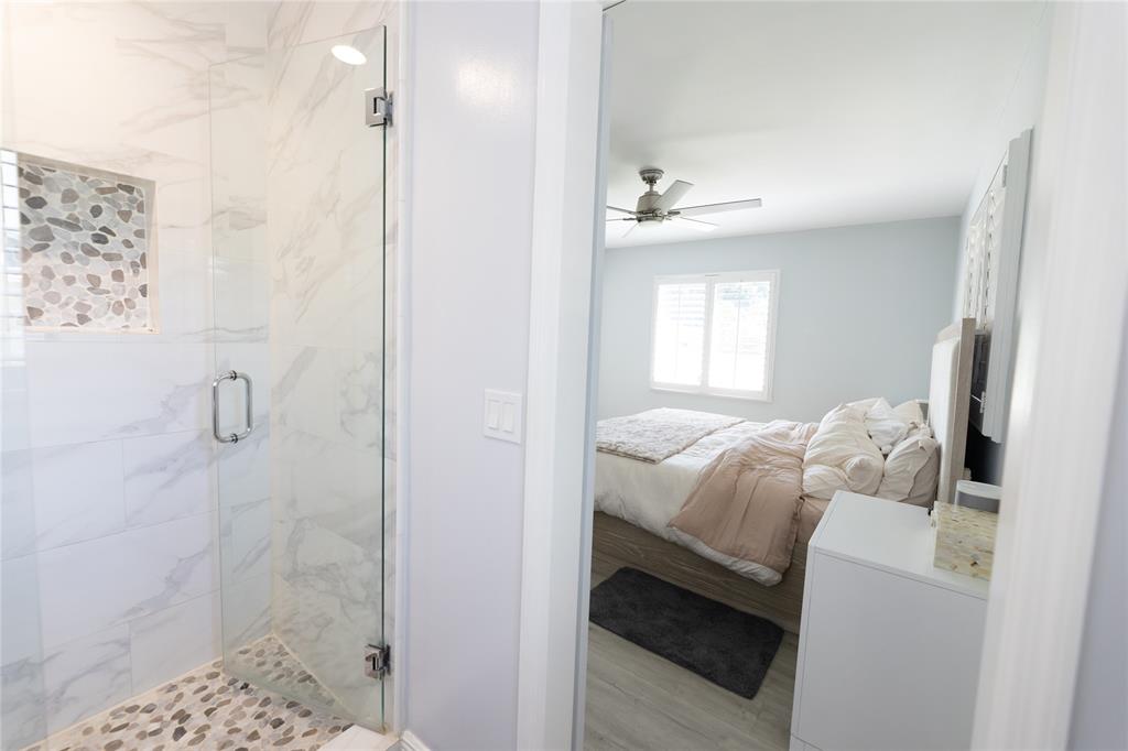 1497 Southwest Buckskin Trail Stuart, FL 34997 - Photo 17 of 48 a bedroom with a bed and a window