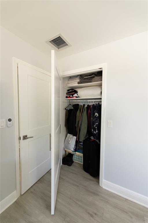 1497 Southwest Buckskin Trail Stuart, FL 34997 - Photo 21 of 48 a view of walk in closet with clothes and shoes