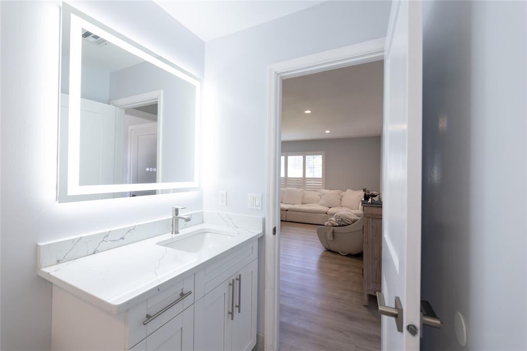 1497 Southwest Buckskin Trail Stuart, FL 34997 - Photo 25 of 48 a bathroom with a sink toilet and a mirror