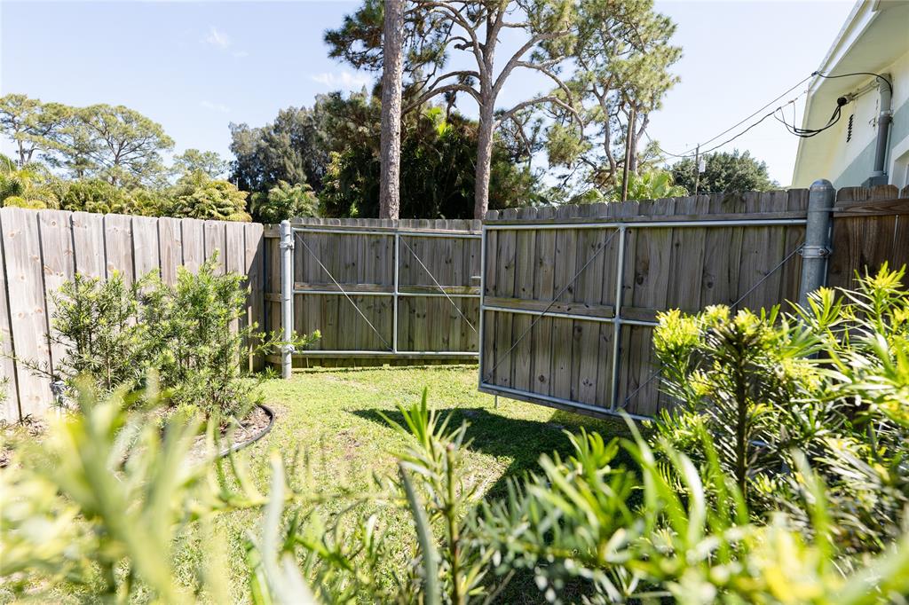 1497 Southwest Buckskin Trail Stuart, FL 34997 - Photo 37 of 48 a view of a backyard with a garden