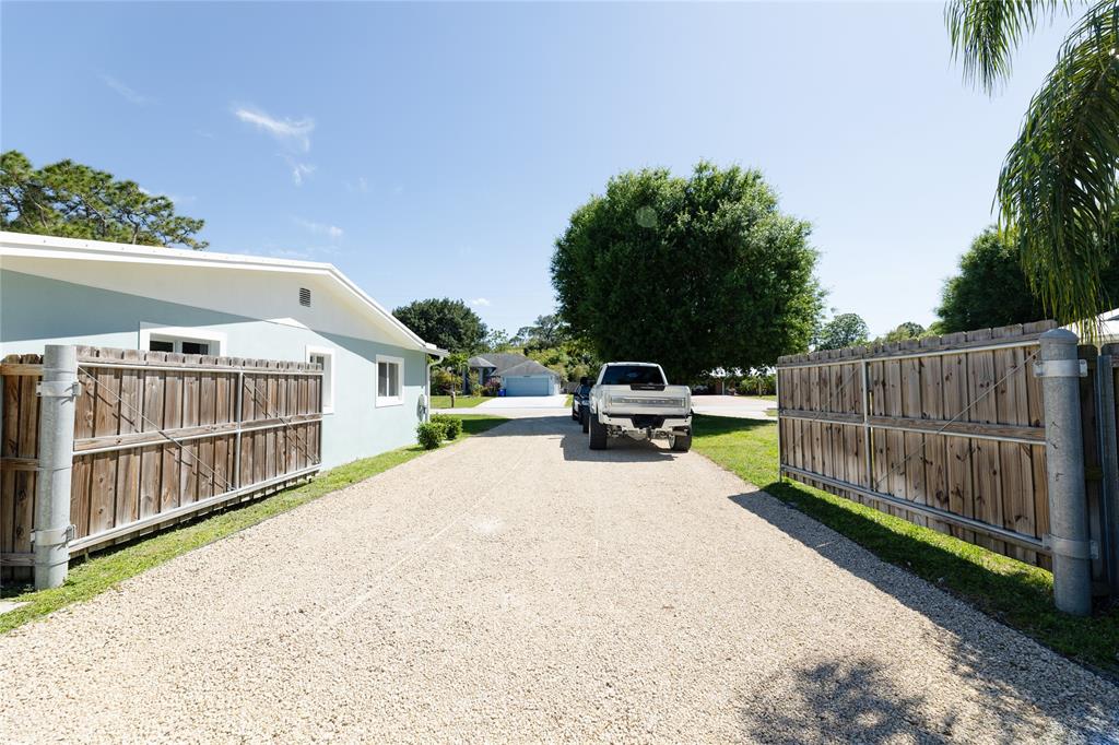 1497 Southwest Buckskin Trail Stuart, FL 34997 - Photo 38 of 48 a view of a house with wooden fence