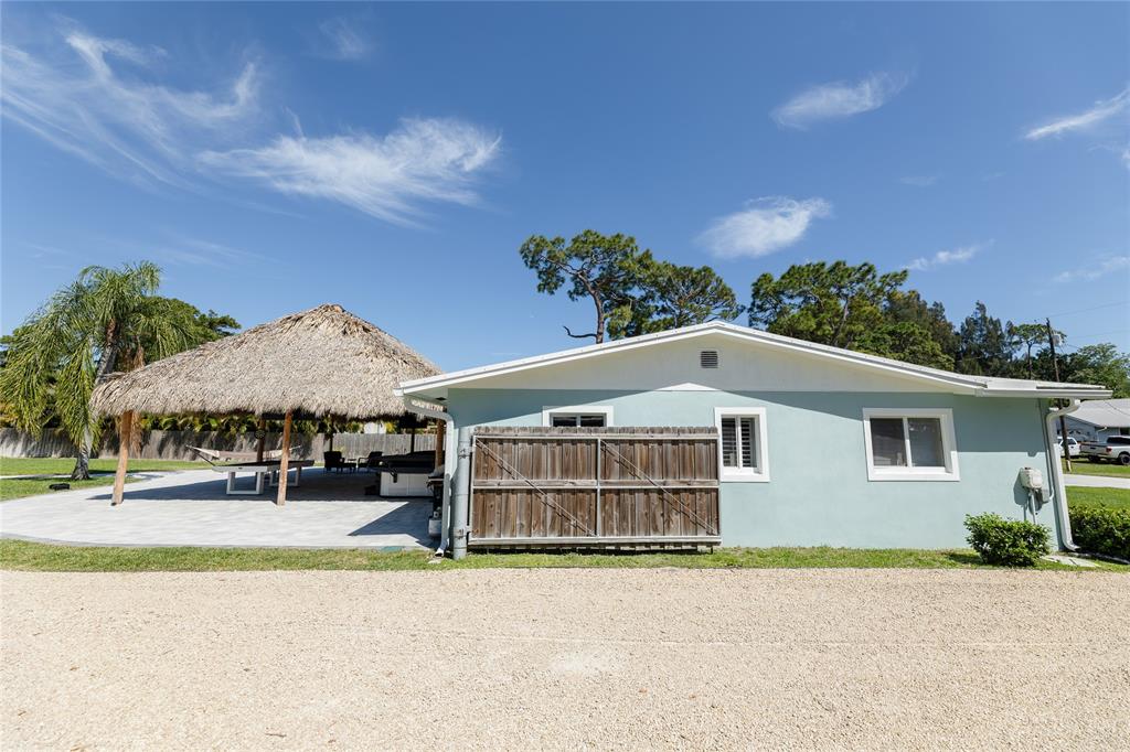 1497 Southwest Buckskin Trail Stuart, FL 34997 - Photo 39 of 48 a front view of a house with a yard