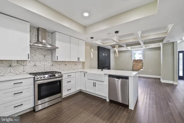 a kitchen with a stove oven and white cabinets