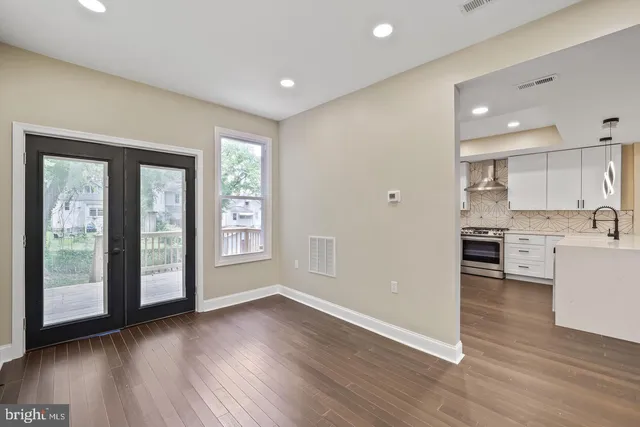 a view of a kitchen with wooden floor and a window