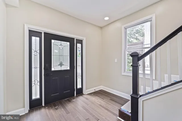 a view of front door with wooden floor