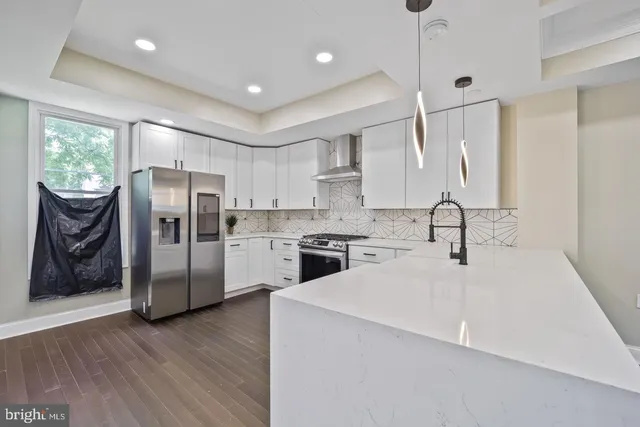 a kitchen with a refrigerator a sink and cabinets