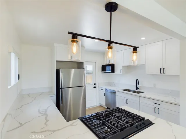 a kitchen with stainless steel appliances a refrigerator and a sink