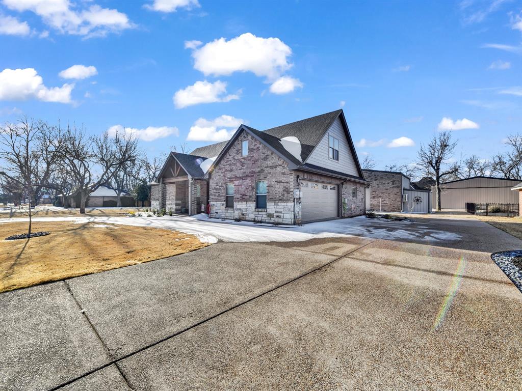 5418 Wedgefield Road Granbury, TX 76049 - Photo 4 of 40 Front of home with hangar in background with storage on right of hangar