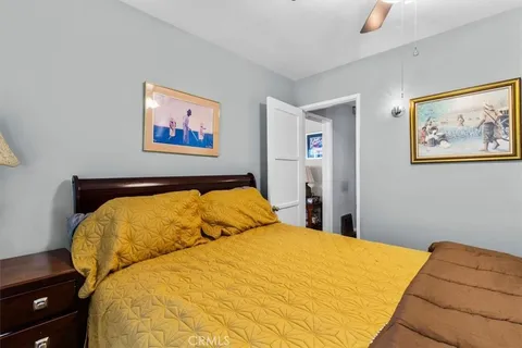 a bed room with a bed and a painting on the wall