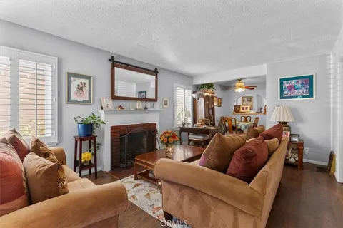 a living room with furniture a window and a fireplace