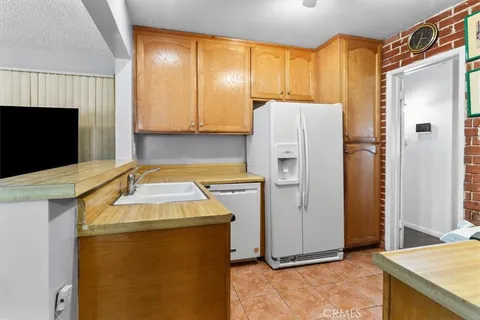 a utility room with refrigerator and window