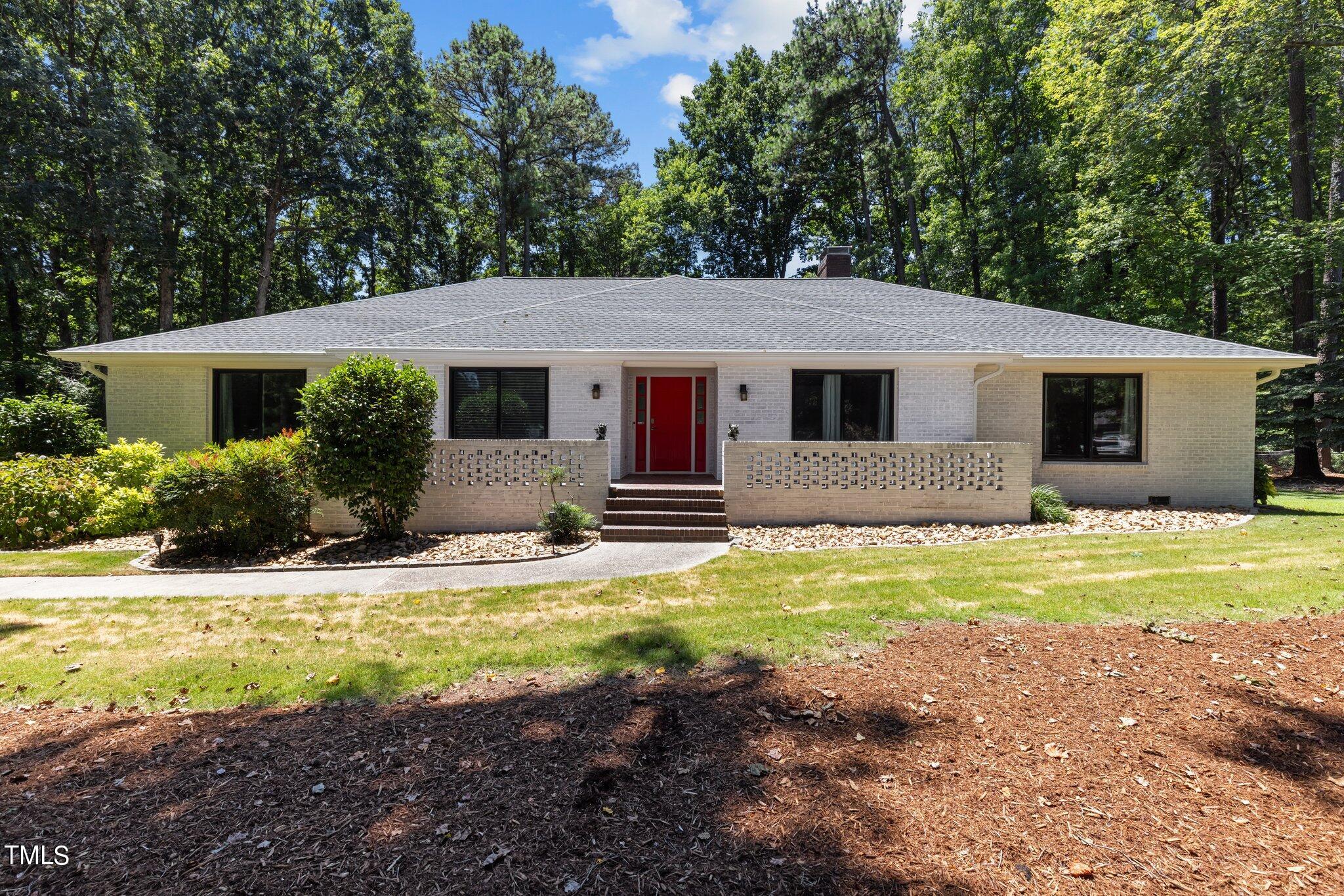 8809 Leesville Road Raleigh, NC 27613 - Photo 1 of 32 a front view of house with yard and trees in the background
