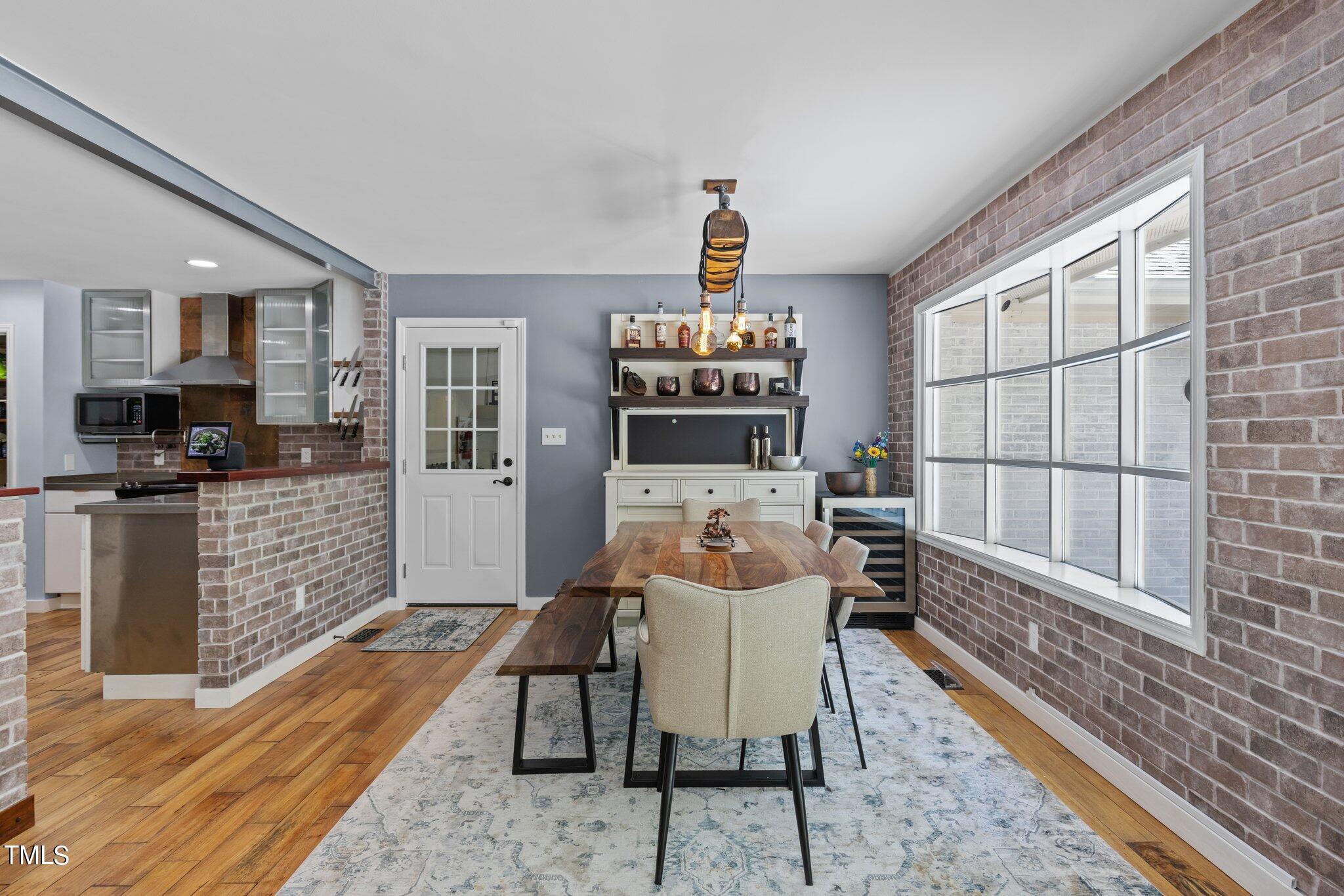 8809 Leesville Road Raleigh, NC 27613 - Photo 16 of 32 a dining room with furniture a rug wooden floor and a rug