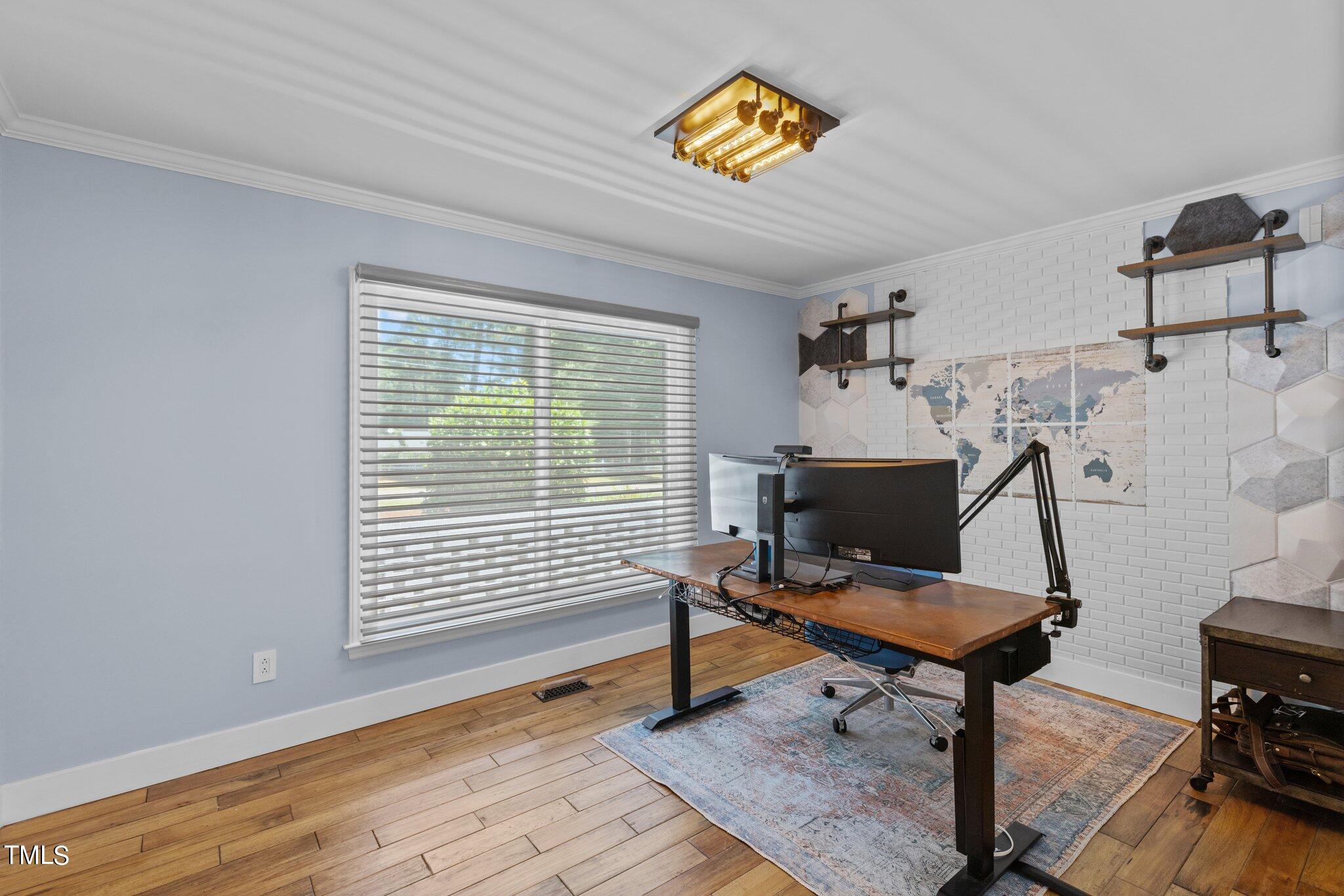8809 Leesville Road Raleigh, NC 27613 - Photo 19 of 32 a view of a workspace with furniture and a window