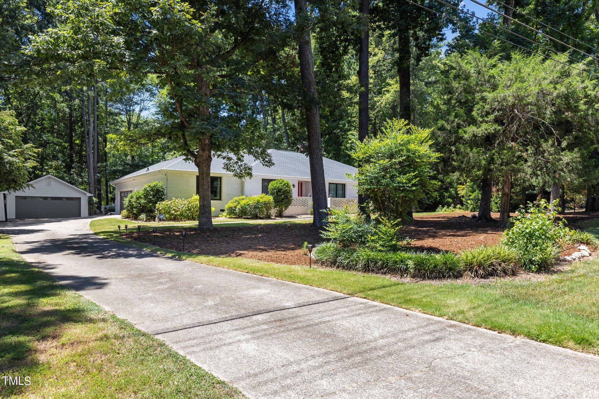 8809 Leesville Road Raleigh, NC 27613 - Photo 2 of 32 front view of a house with a yard and potted plants