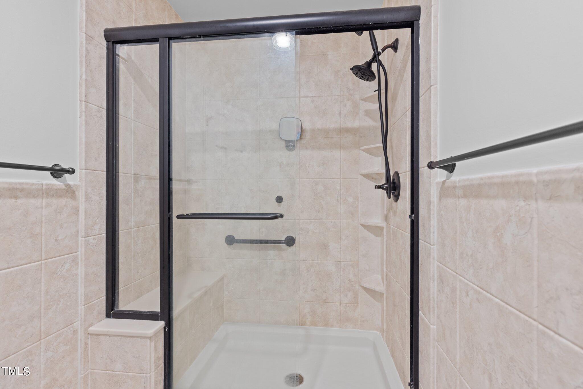 8809 Leesville Road Raleigh, NC 27613 - Photo 22 of 32 a bathroom with a glass shower door