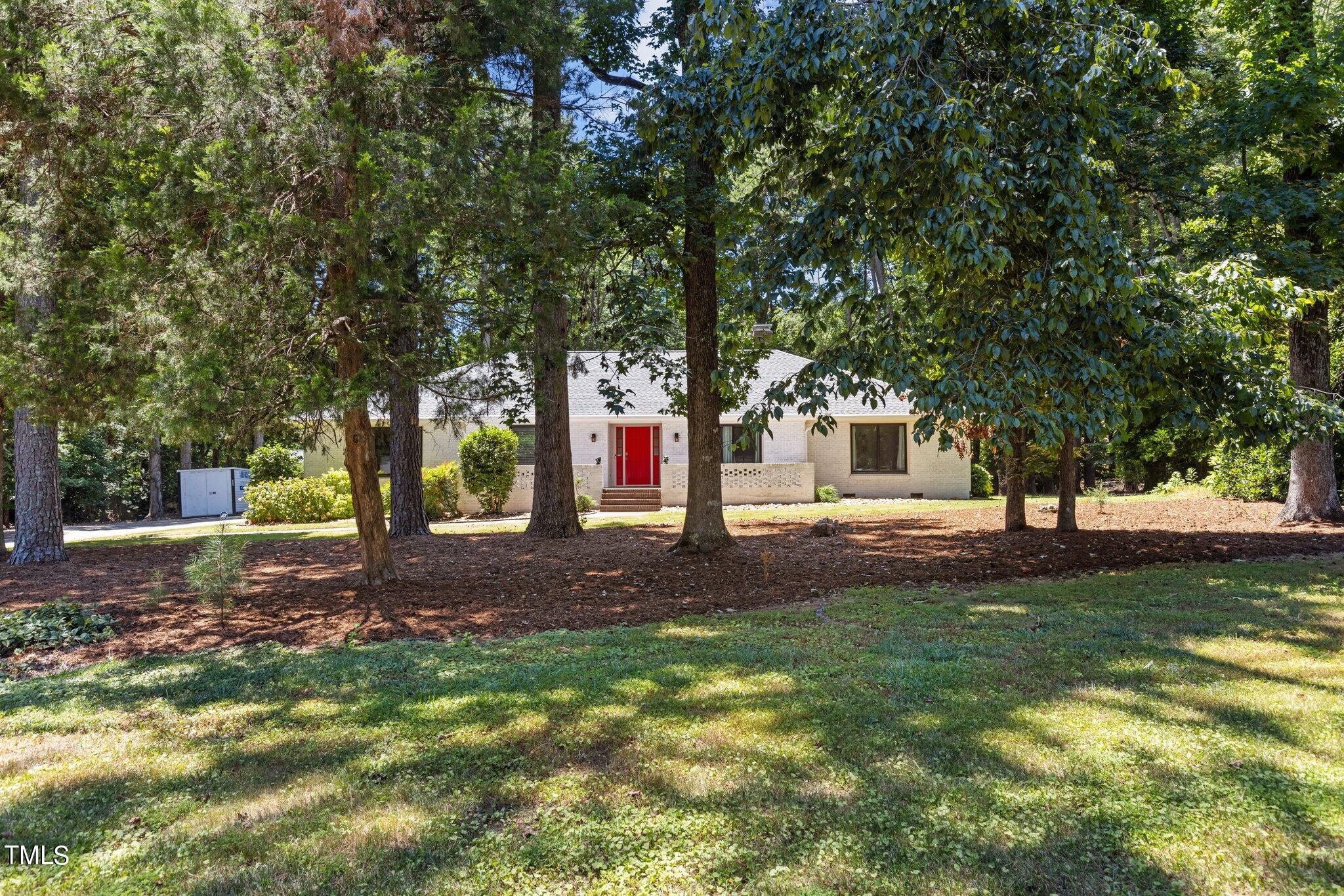 8809 Leesville Road Raleigh, NC 27613 - Photo 3 of 32 a front view of a house with a yard and garage