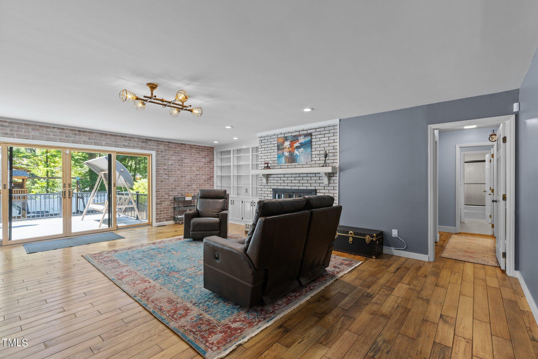 8809 Leesville Road Raleigh, NC 27613 - Photo 5 of 32 a living room with furniture and a fireplace