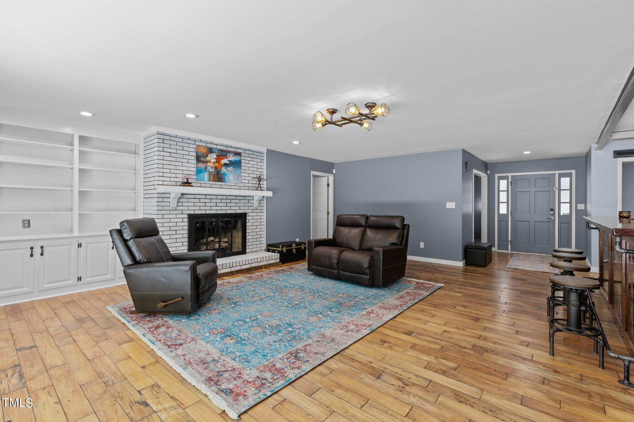 8809 Leesville Road Raleigh, NC 27613 - Photo 6 of 32 a living room with furniture and a fireplace
