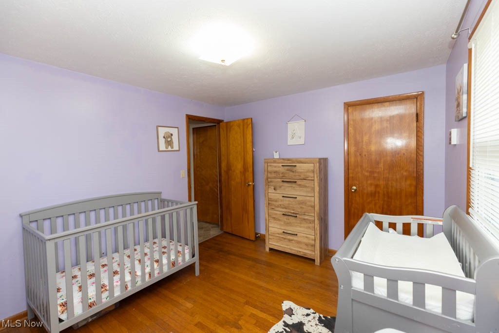 1085 Novak Road Grafton, OH 44044 - Photo 20 of 41 Bedroom featuring a crib, wood finished floors, and a closet