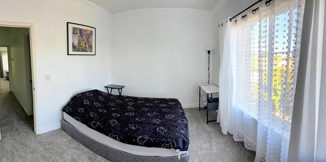 a bedroom with bed and a window