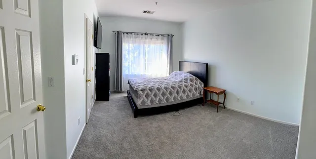 a bedroom with a bed and a window