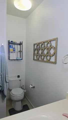 a bathroom with a toilet and a picture of toilet
