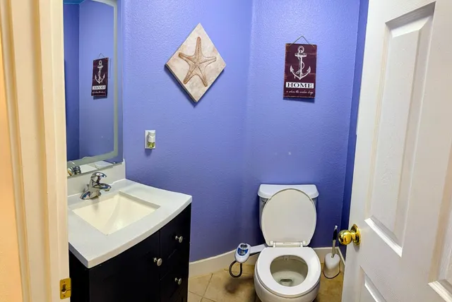 a bathroom with a toilet a sink and a mirror