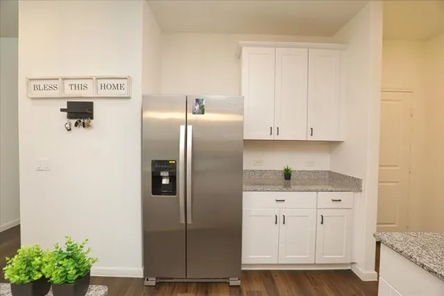 a kitchen with stainless steel appliances granite countertop a refrigerator and a stove