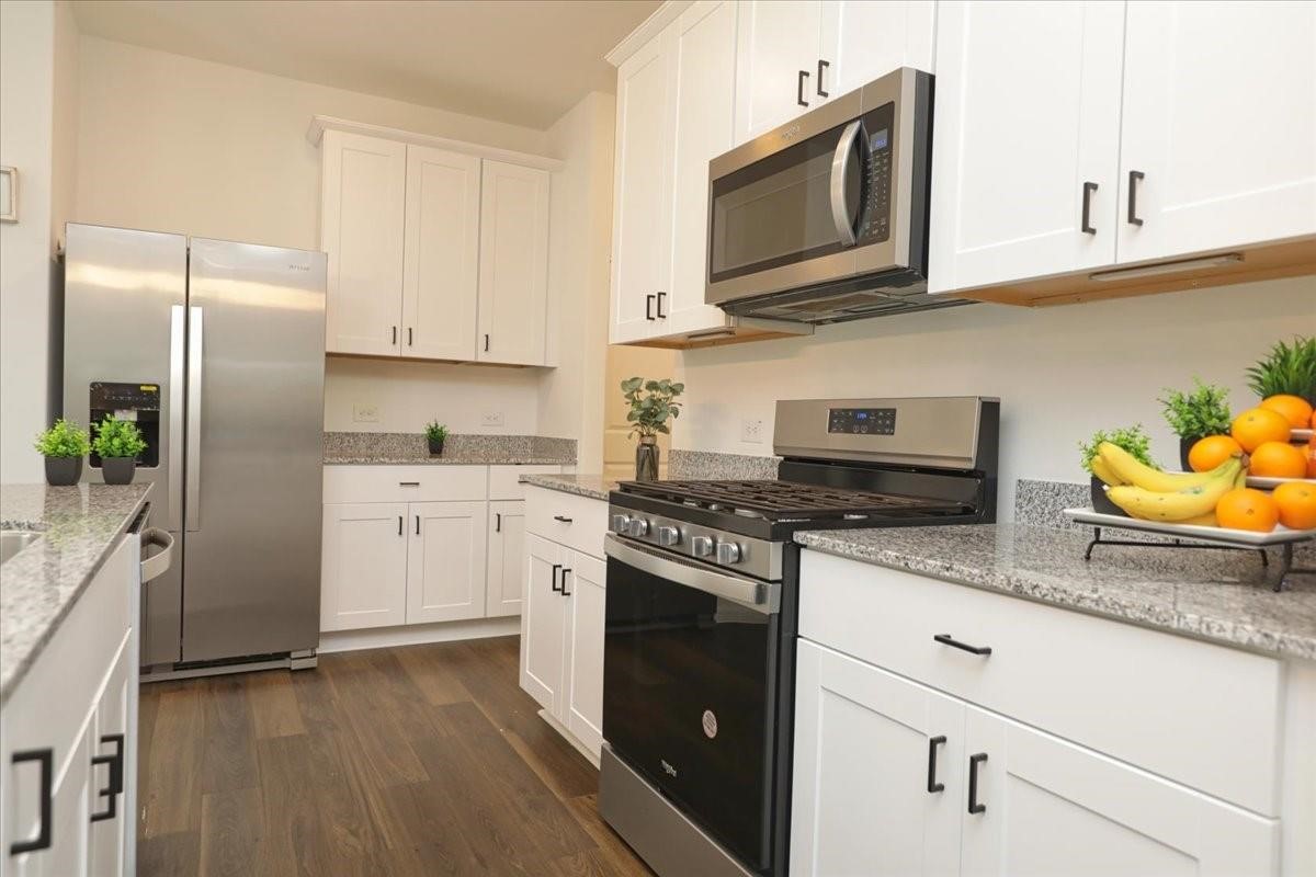 14463 Cedar Br Lane Conroe, TX 77302 - Photo 21 of 50 a kitchen with stainless steel appliances granite countertop a refrigerator sink stove microwave and cabinets