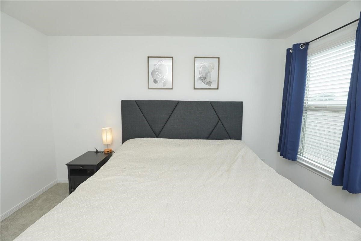 14463 Cedar Br Lane Conroe, TX 77302 - Photo 24 of 50 a bedroom with a bed and a window