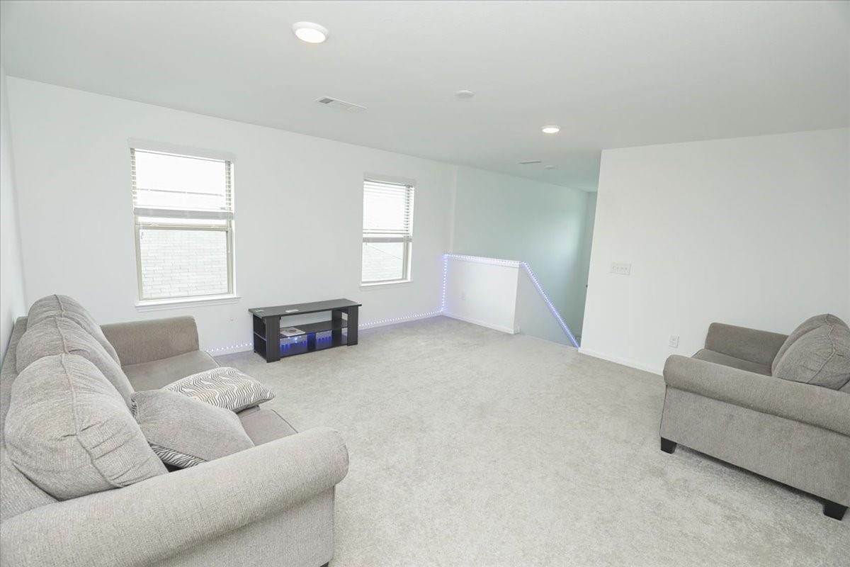 14463 Cedar Br Lane Conroe, TX 77302 - Photo 30 of 50 a living room with furniture and a couch